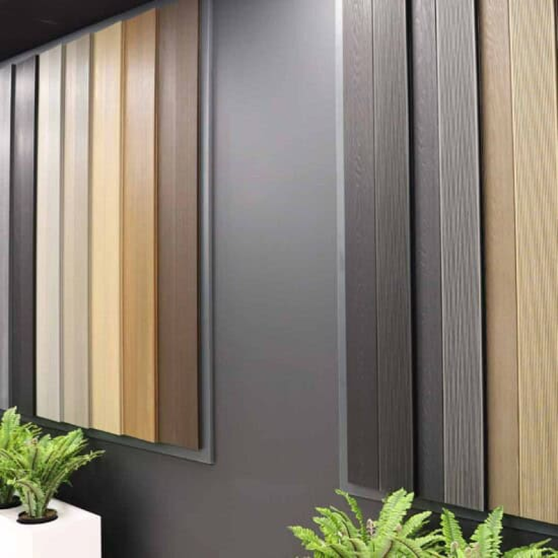 Wall display of vertical wood panel samples in various colours.