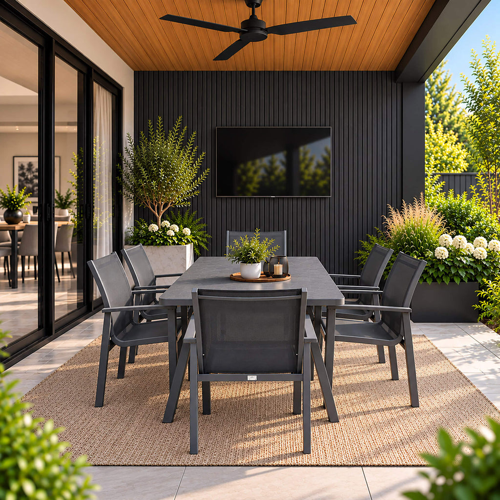 An Outdoor veranda with Charcoal Outdoor Slatwall Cladding in the background and Dark Grey Dining Set