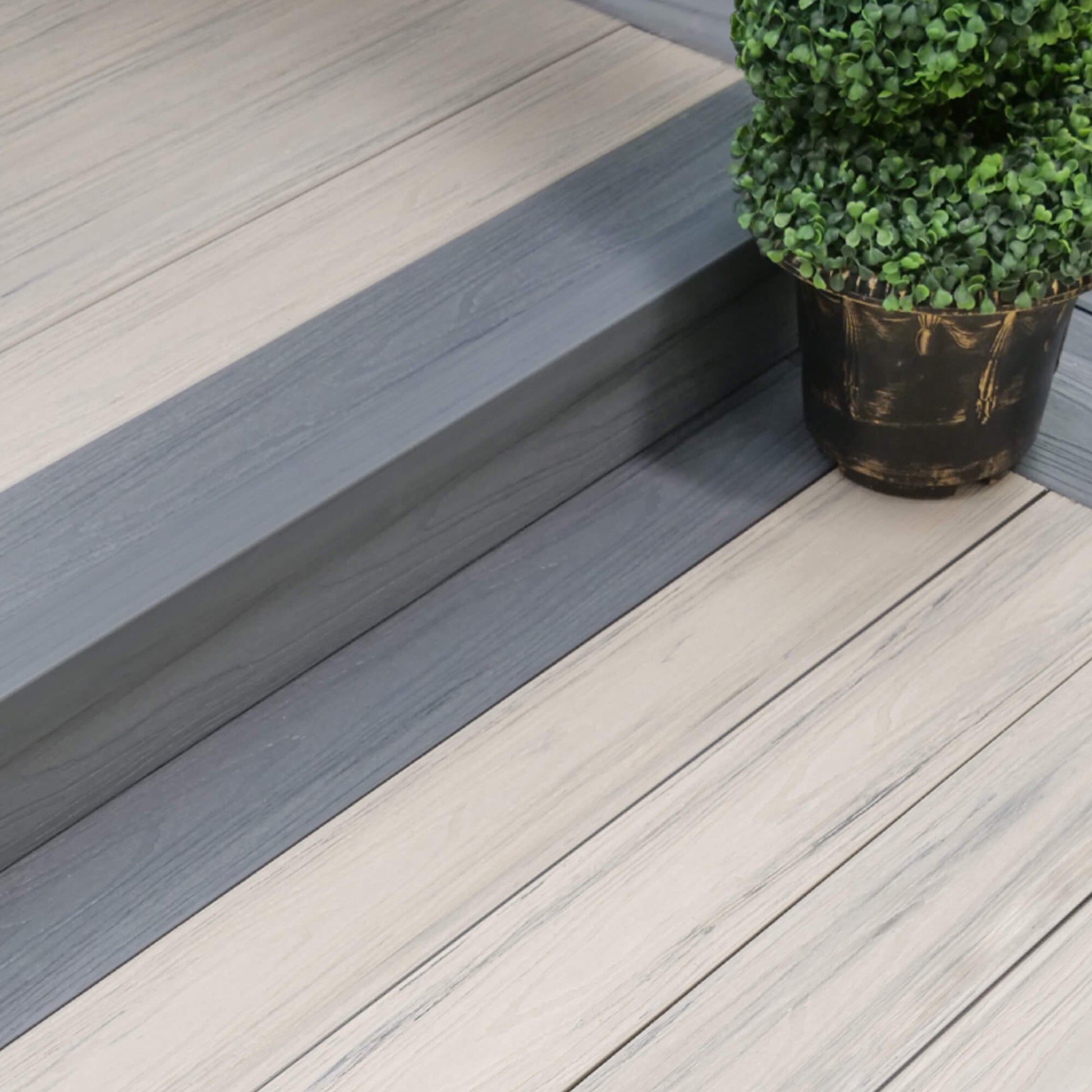 Co-Extruded Ivory/Slate Grey Composite Decking in situ in a patio setting.