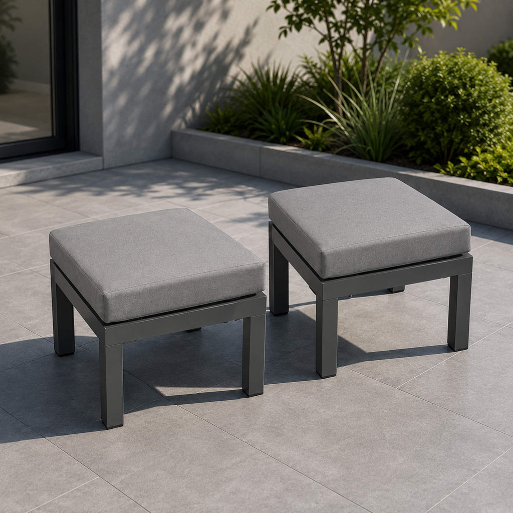 Set of Como Dark Grey outdoor stools on a patio.