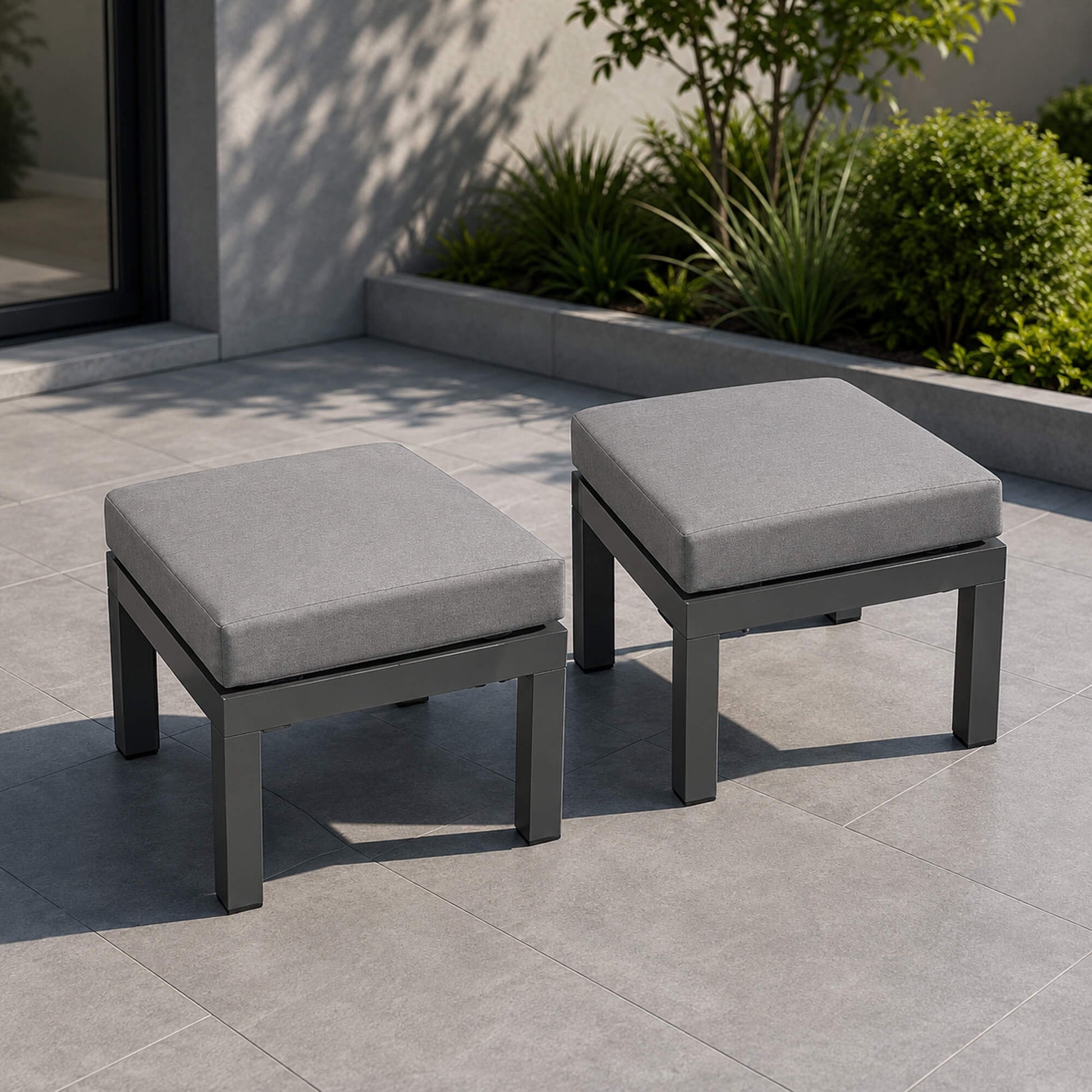 Set of Como Dark Grey outdoor stools on a patio.