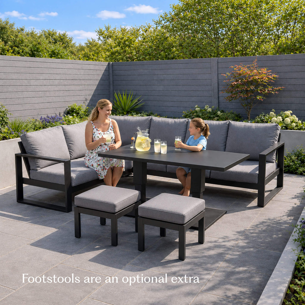 Mother and daughter sitting on a Como dark grey L-shaped outdoor furniture corner set with matching stool set.