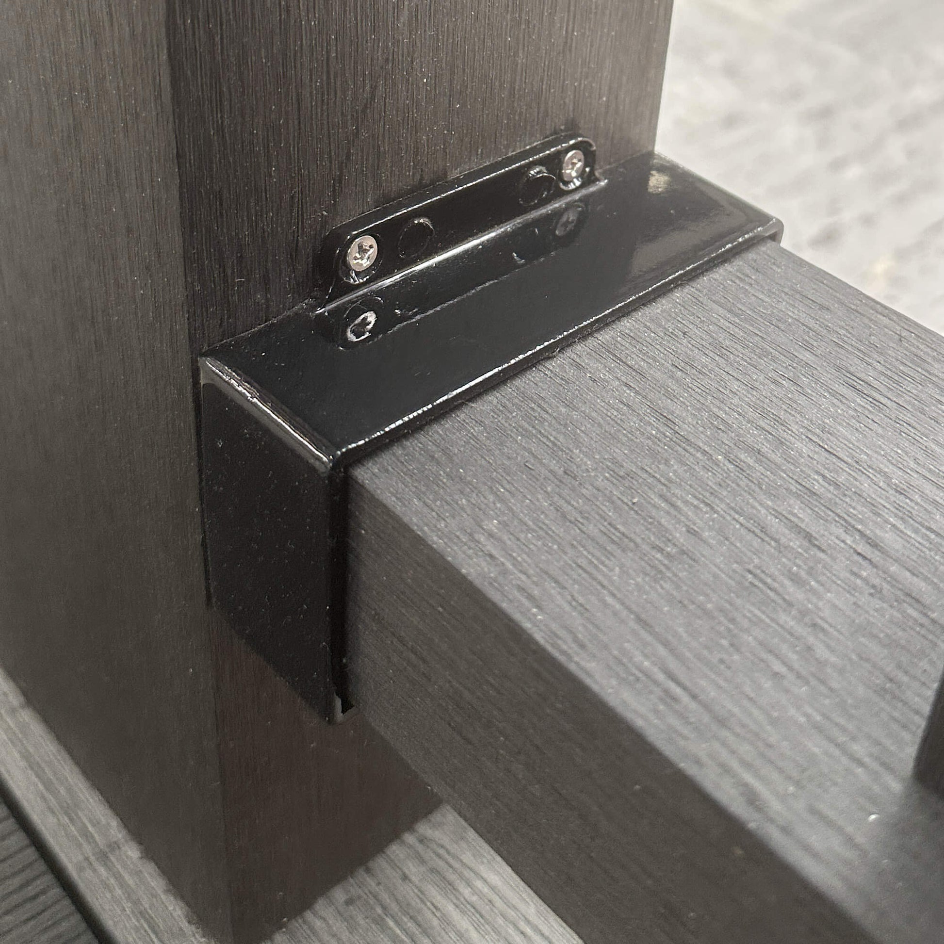 Close-up of a Charcoal Composite Handrail connected to a Composite Post with a Handrail Bracket.