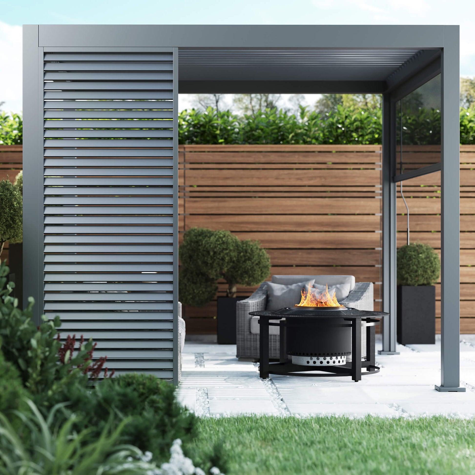 A side perspective of a Riva 3x3m Aluminium Pergola in a garden patio setting showcasing a Louvre Wall Panel.