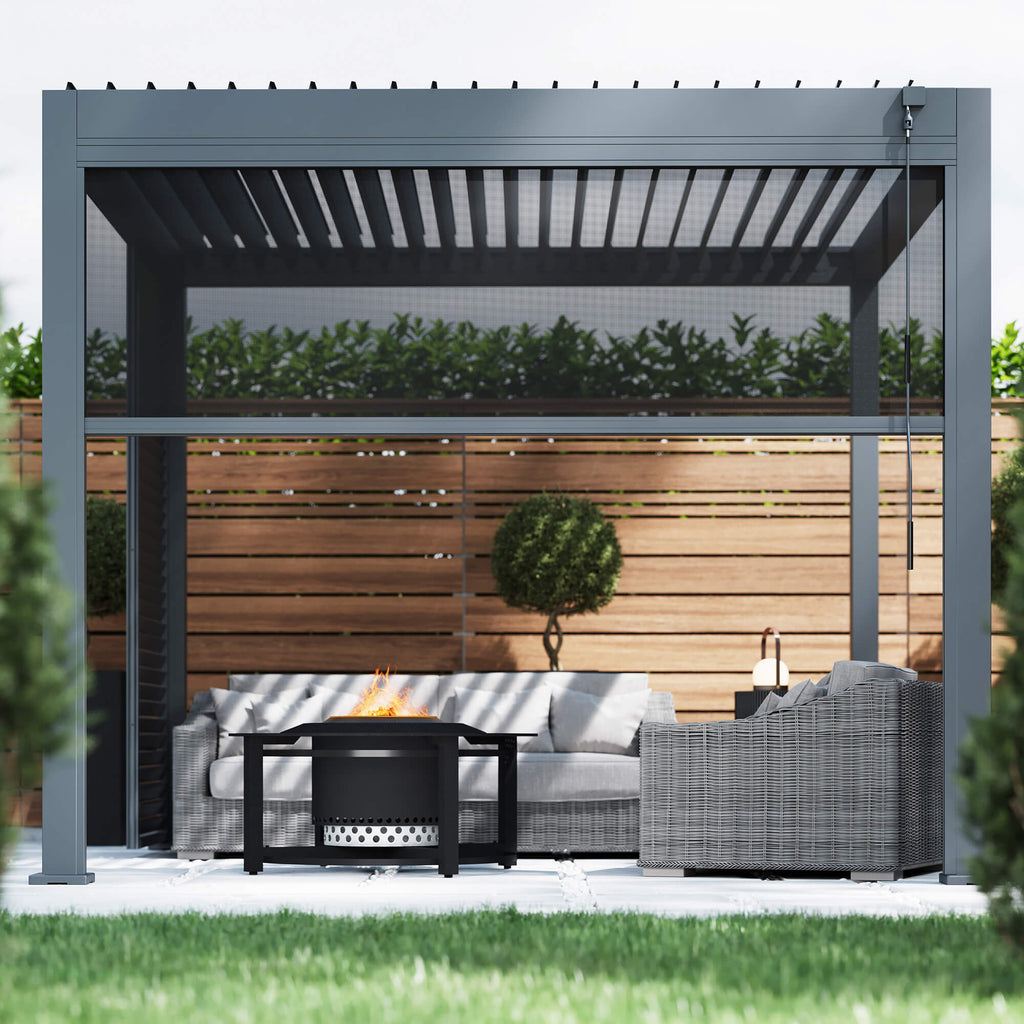 A front perspective of a Riva 3x3m Aluminium Pergola with a blind, outdoor furniture, and fire pit in an garden patio setting. 