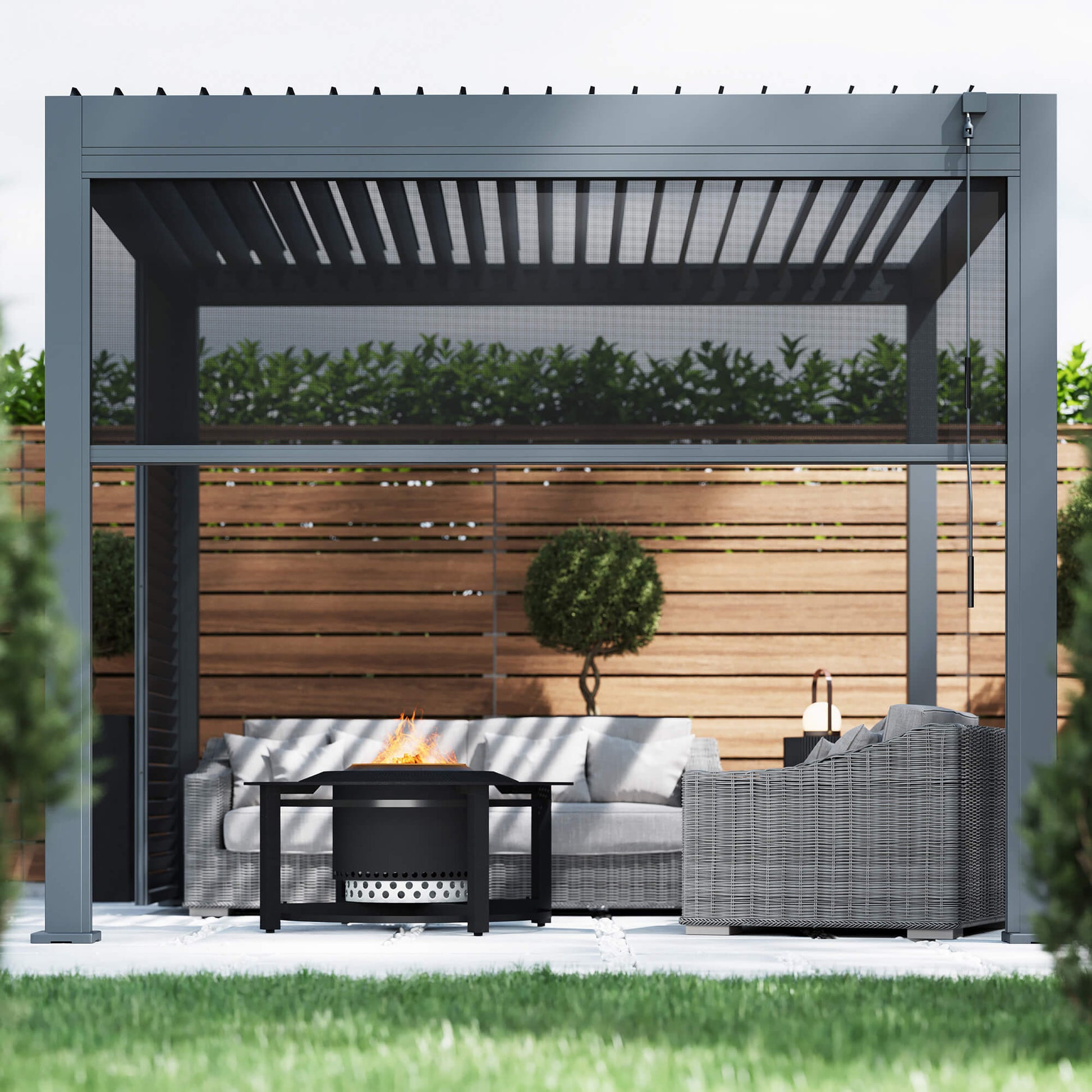 A front perspective of a Riva 3x3m Aluminium Pergola with a blind, outdoor furniture, and fire pit in an garden patio setting. 