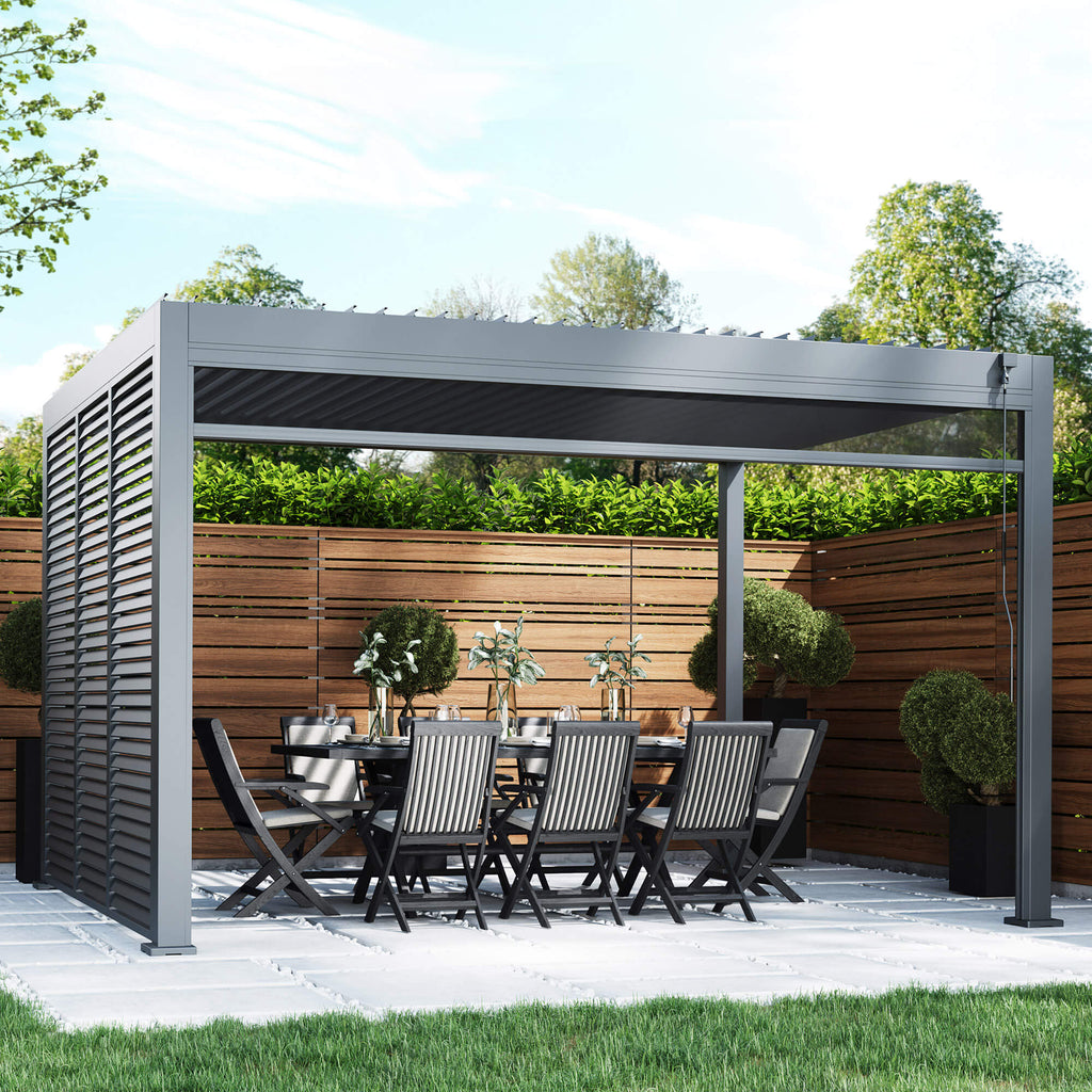 A Riva 4x3m Aluminium Pergola, dining table, and chairs in an outdoor patio setting.